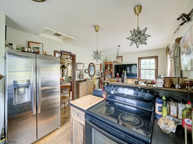 a kitchen with refrigerator and cabinets