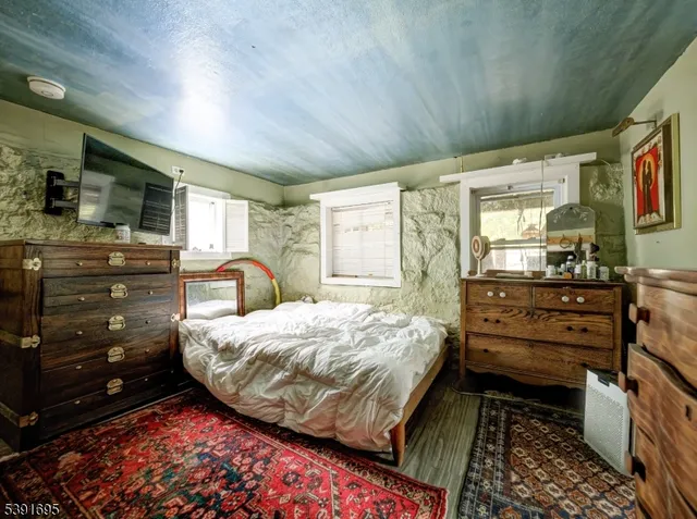 a bedroom with a bed and a dresser