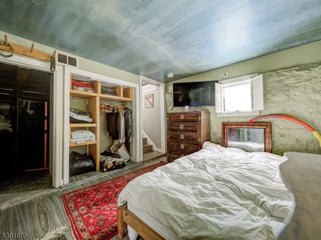 a bedroom with a bed and a mirror