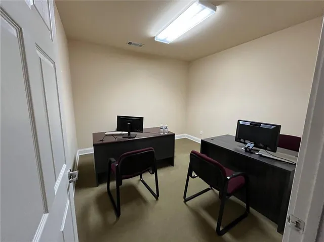 a view of a workspace with furniture