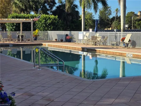 a view of a swimming pool with a patio and a swimming pool