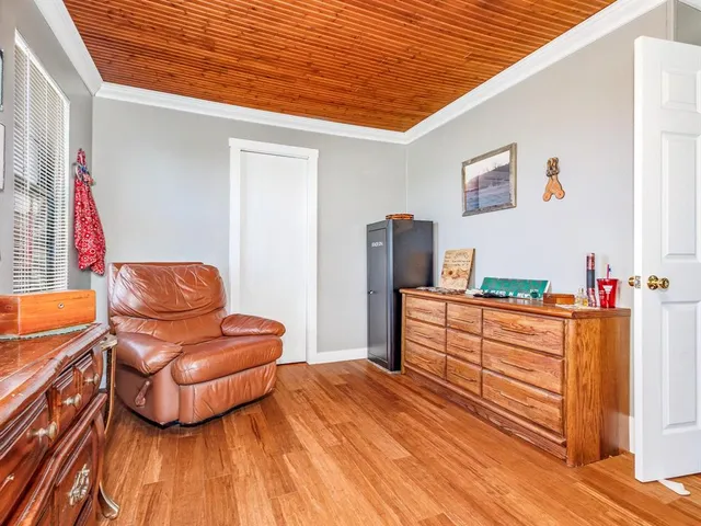 a bedroom with furniture and wooden floor