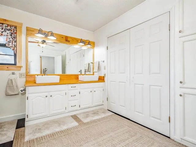 a spacious bathroom with a double vanity sink and a mirror