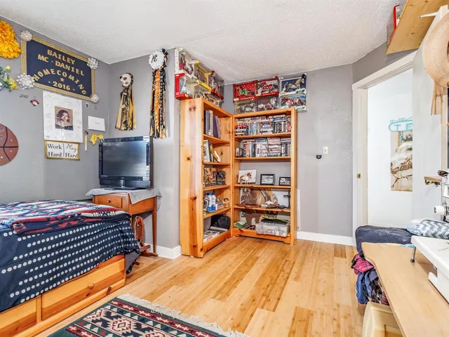 a bedroom with a bed and a book shelf
