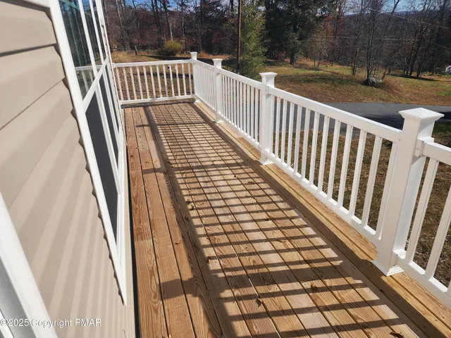 a view of a balcony with wooden floor