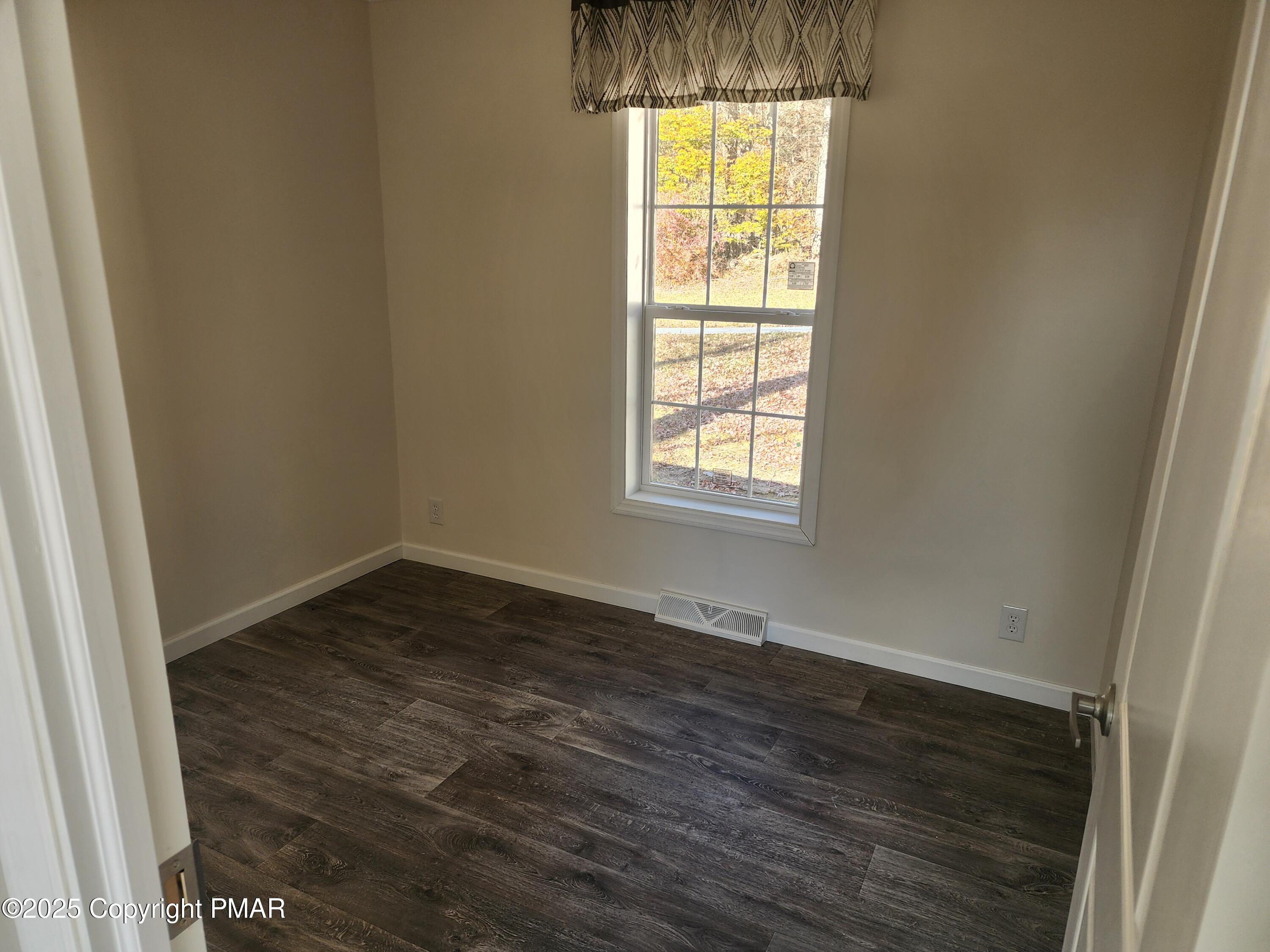 3633 Rocky Hl Road White Haven, PA 18661 - Photo 7 of 7 an empty room with wooden floor and windows