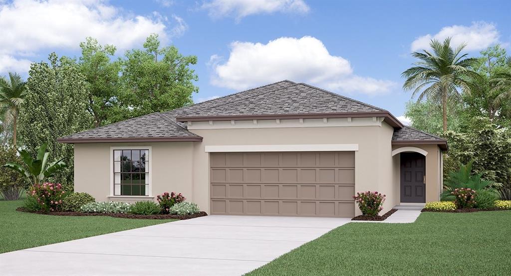 7057 Emerald Spring Loop New Port Richey, FL 34653 - Photo 1 of 1 a front view of a house with a garden and plants