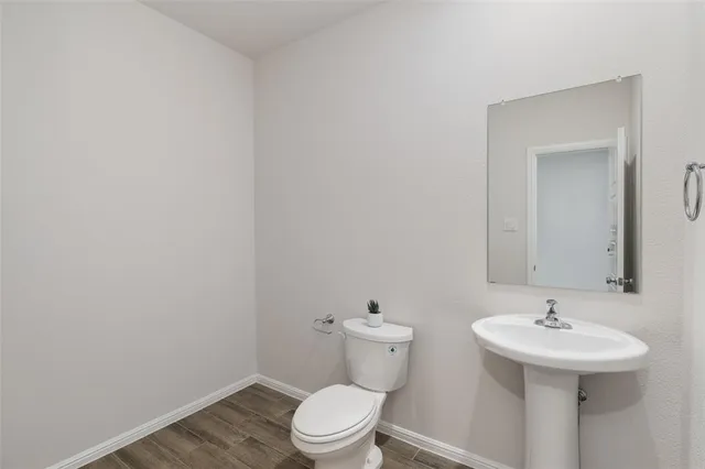 a bathroom with a sink toilet and a mirror