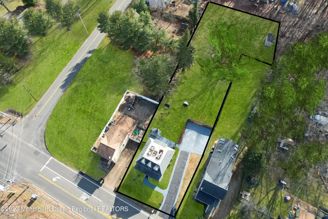 an aerial view of a house with a garden and trees