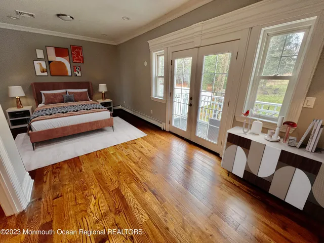 a bedroom with furniture and a large window
