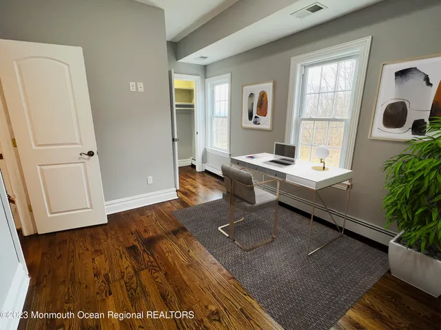 a room with pool table and windows