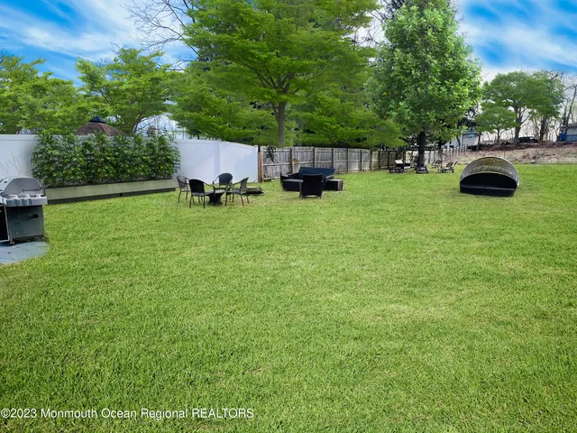 a view of a backyard with sitting area