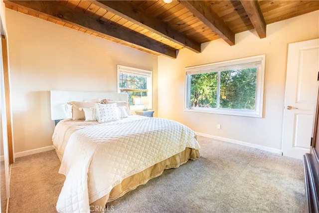 a spacious bedroom with a bed and a large window