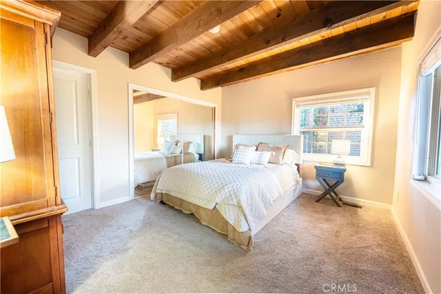 a bed room with a bed and a chair