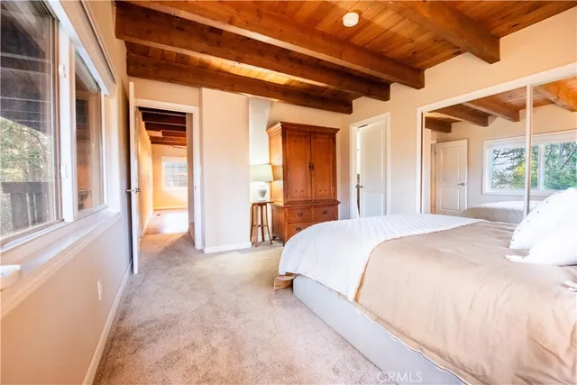 a spacious bedroom with a large bed and a large window with the outer view