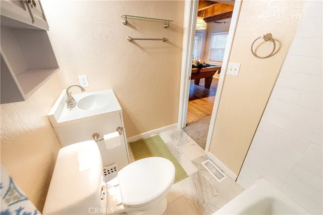 a bathroom with a sink mirror vanity and toilet