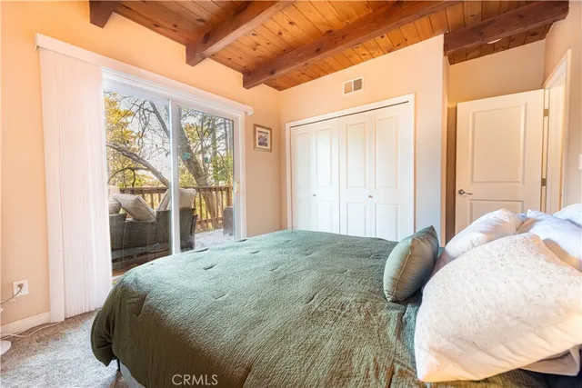 a bed sitting in a bedroom next to a window