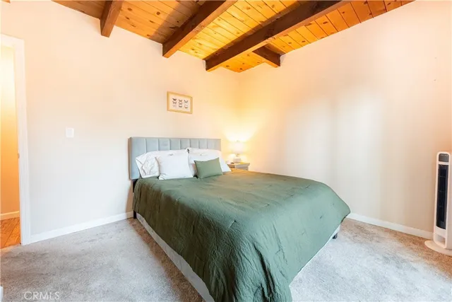 a bedroom with a bed and a night stand