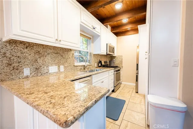 a kitchen with stainless steel appliances granite countertop a sink and cabinets