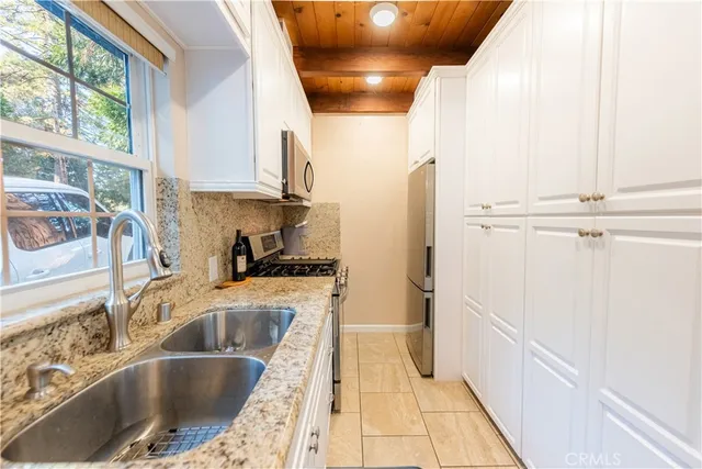 a kitchen with a sink and a refrigerator