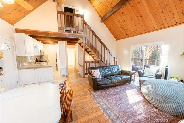 a living room with furniture and a kitchen view