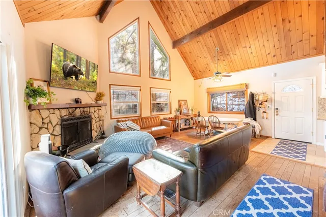 a living room with fireplace furniture and a rug