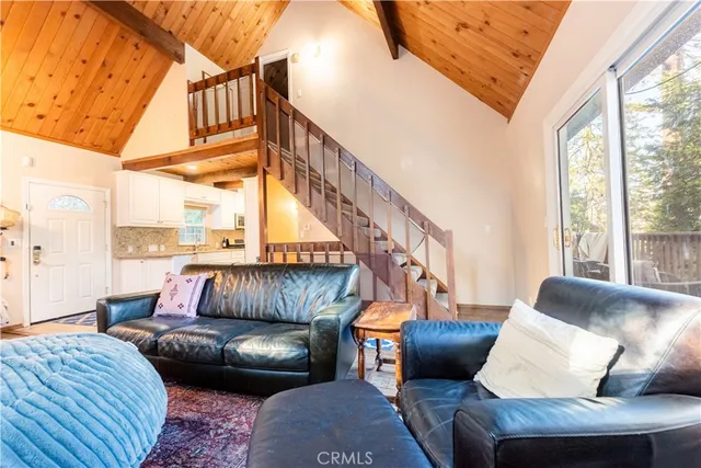 a bedroom with furniture and a large window
