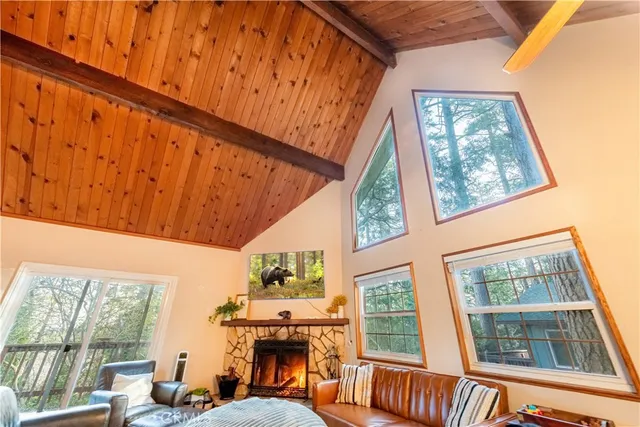 a view of a living room with a fireplace and a window