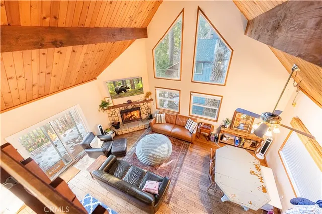 swimming pool view with a couch and wooden floor