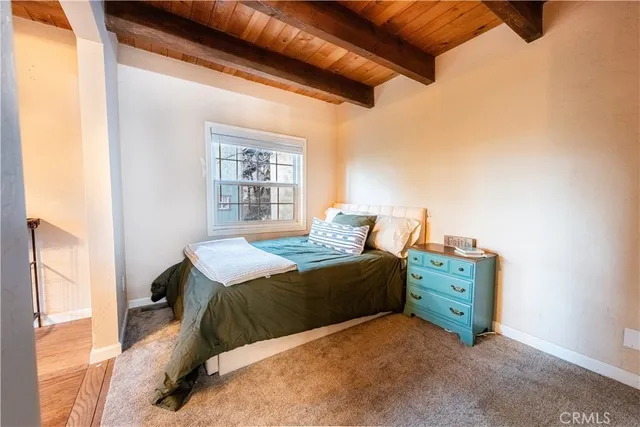 a bed sitting in a bedroom next to a window