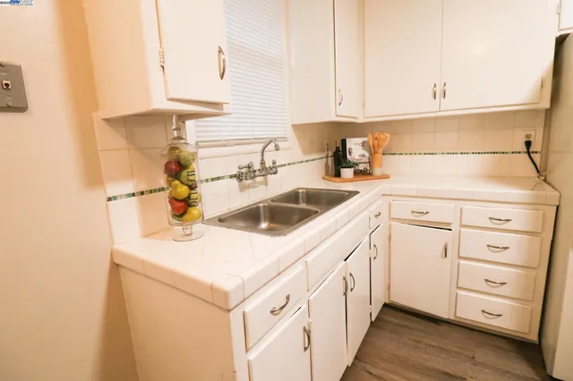 a kitchen with cabinets and white appliances