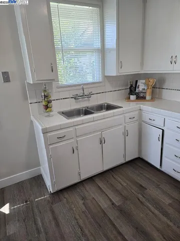 a kitchen with a sink cabinets and window
