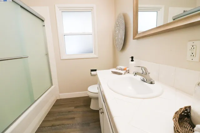 a bathroom with a sink a toilet and vanity