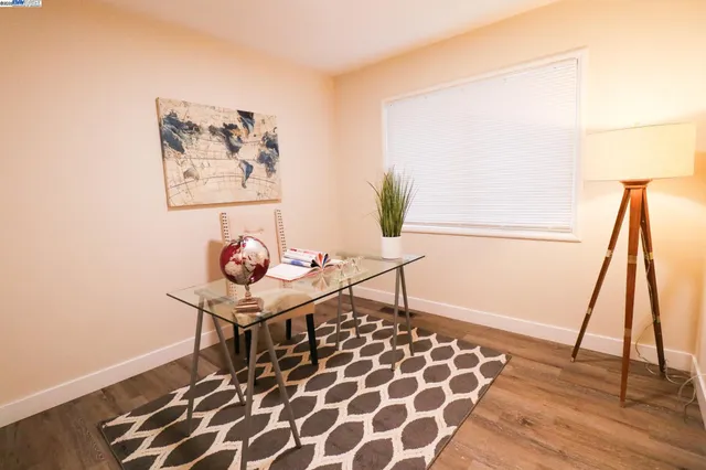a living room with a rug and a table