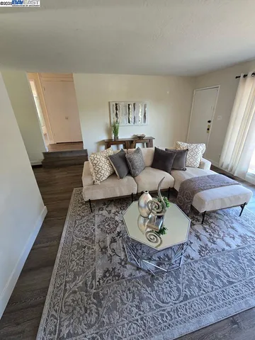 a living room with furniture and a rug