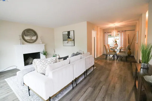 a living room with furniture a fireplace and a large window