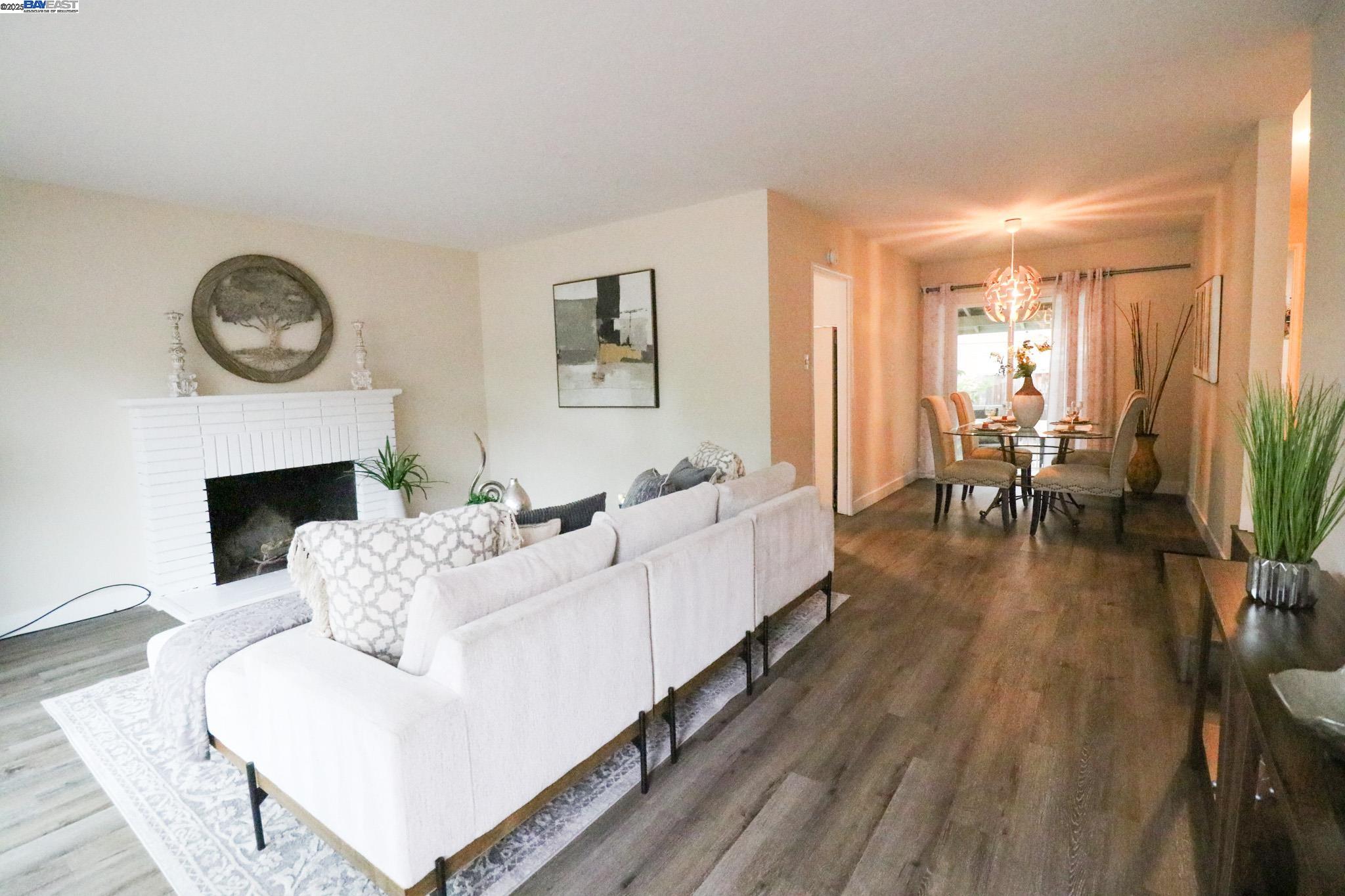 2272 Kelly Street Hayward, CA 94541 - Photo 6 of 32 a living room with furniture a fireplace and a large window