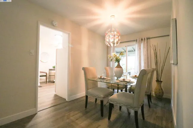 a view of a dining room with furniture and wooden floor