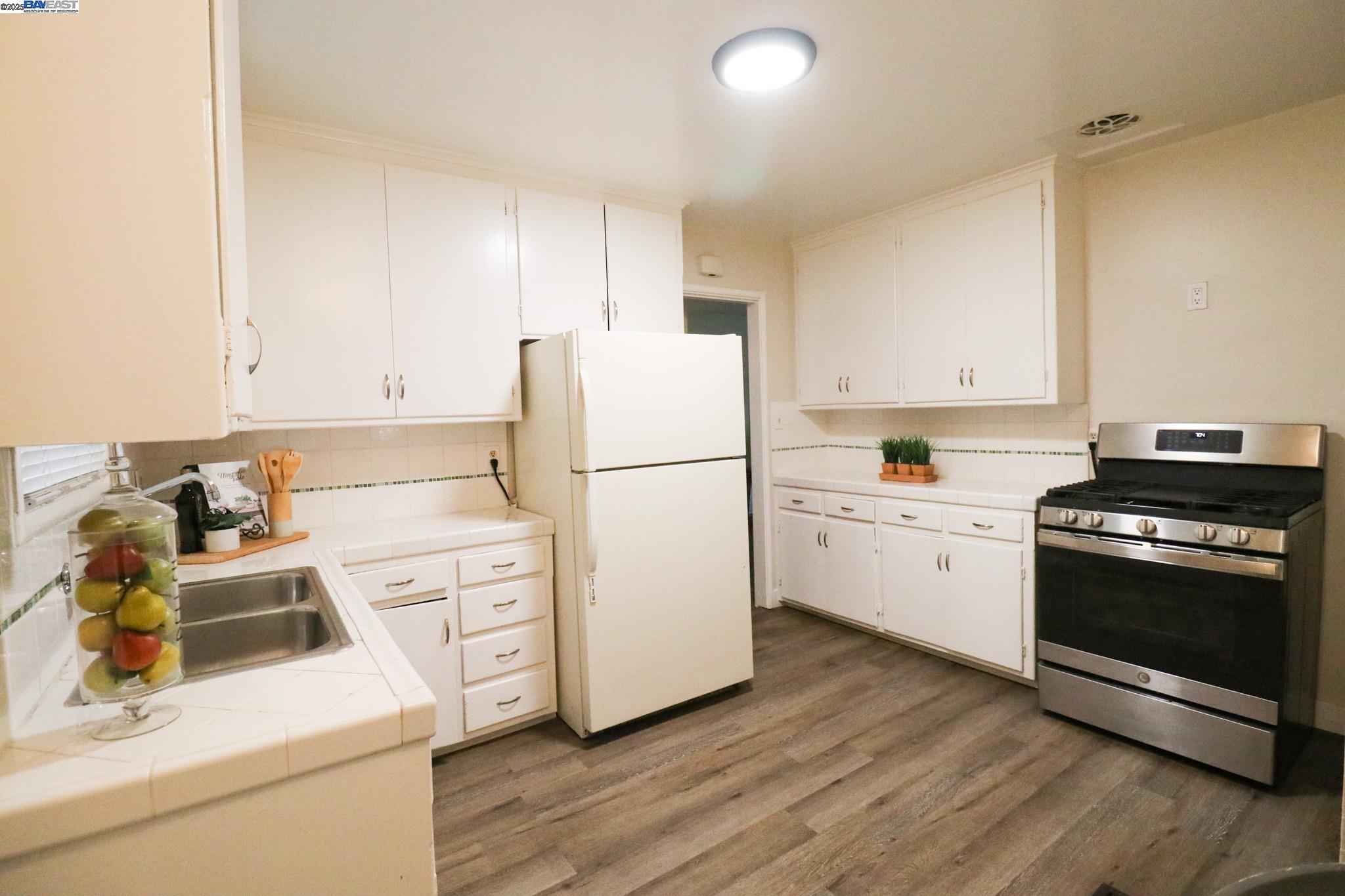 2272 Kelly Street Hayward, CA 94541 - Photo 10 of 32 a kitchen with a white stove top oven and refrigerator