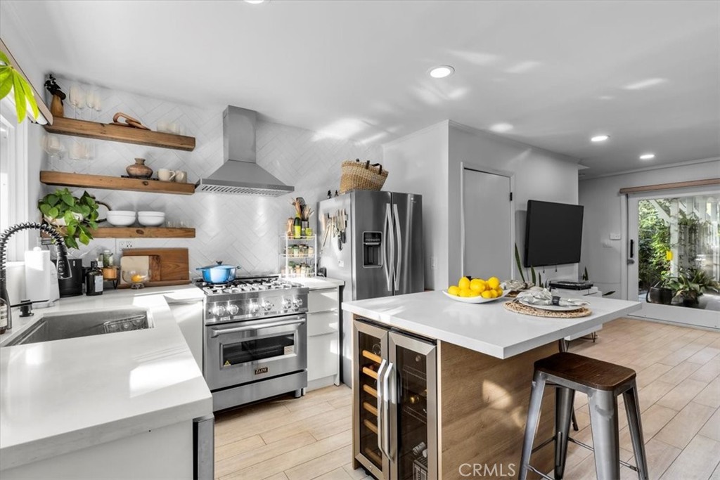 3213 Thatcher Avenue Marina del Rey, CA 90292 - Photo 1 of 1 a kitchen with stainless steel appliances kitchen island granite countertop a stove a sink and a refrigerator