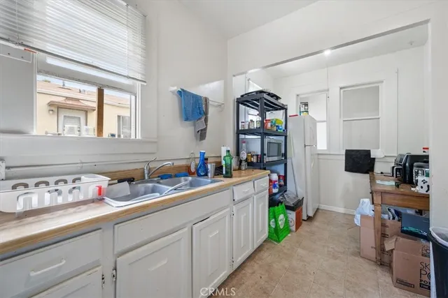 a kitchen with cabinets a sink and a window