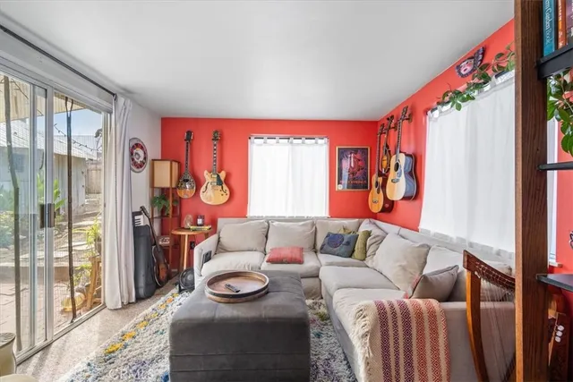 a bedroom with a bed and painting on the wall