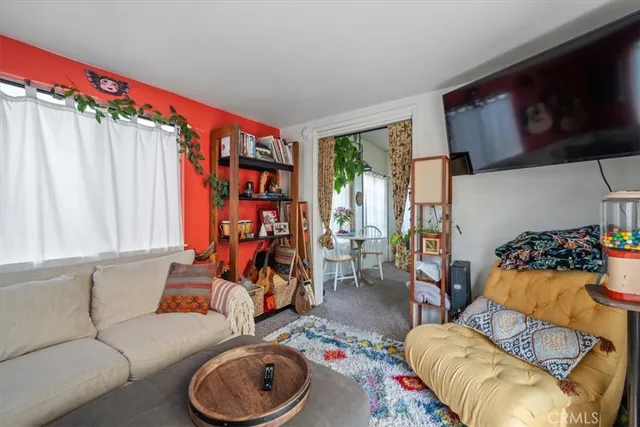 a view of a bedroom with a bed and a window