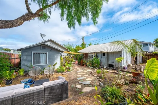 an aerial view of a house with a swimming pool trees and mountains