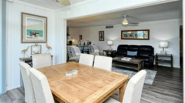 a living room with furniture a rug and a table