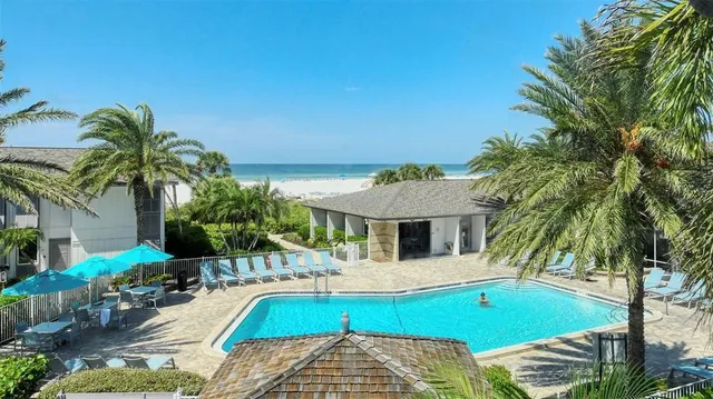 a view of house with swimming pool outdoor seating