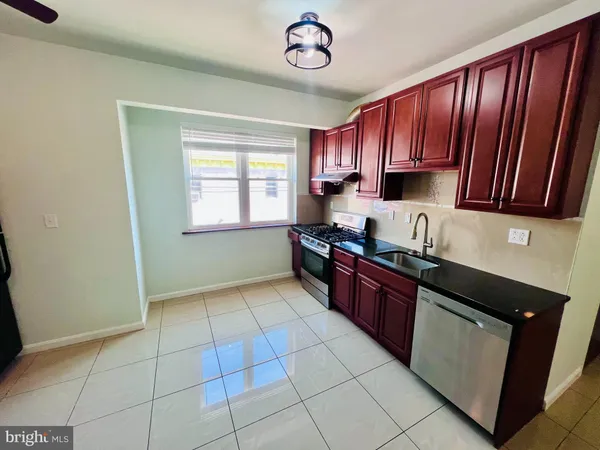 a kitchen with stainless steel appliances granite countertop a stove a sink dishwasher and a refrigerator