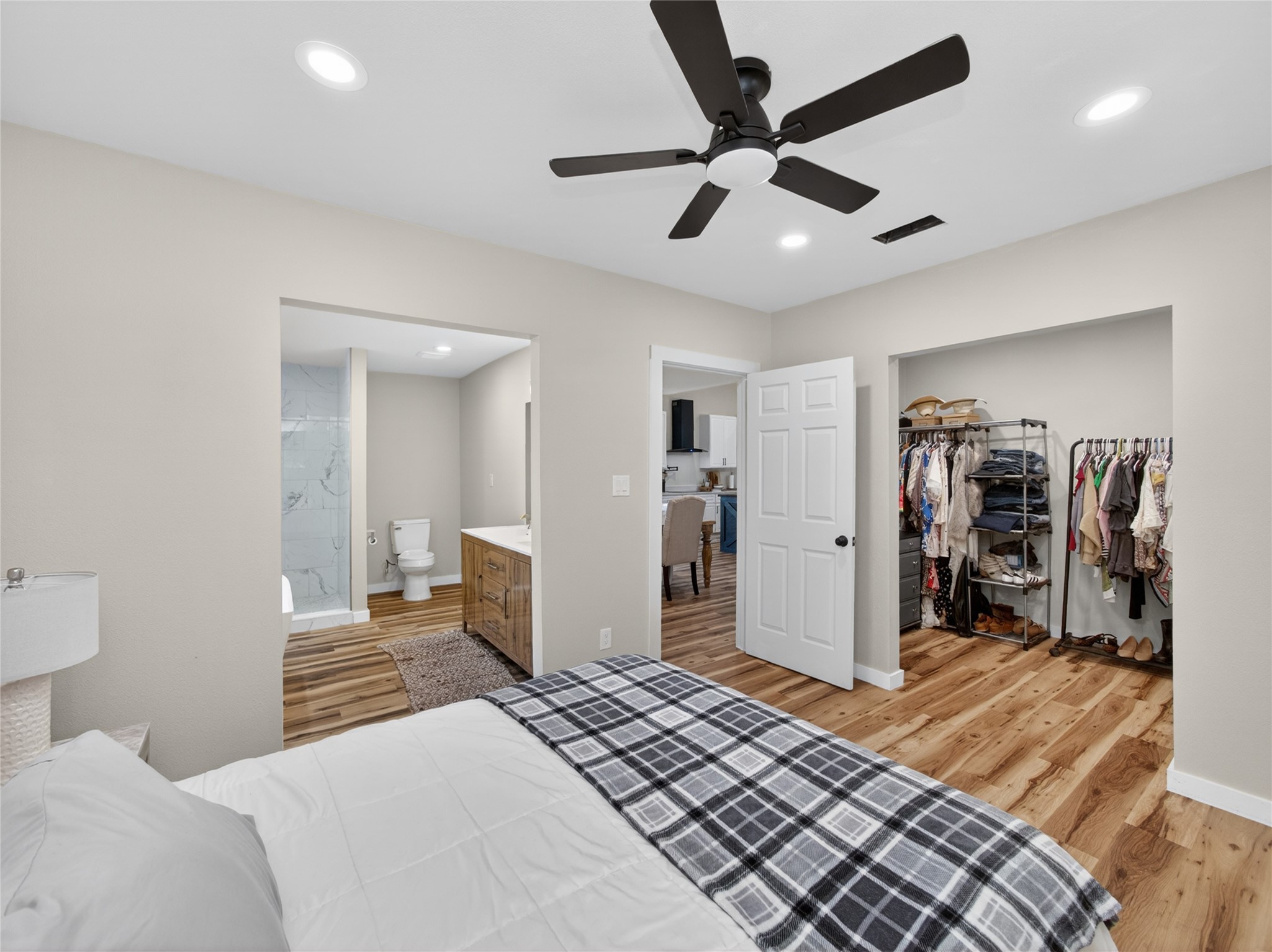 411 Avila Lane Briggs, TX 78608 - Photo 16 of 39 a bedroom with a bed and a walk in closet