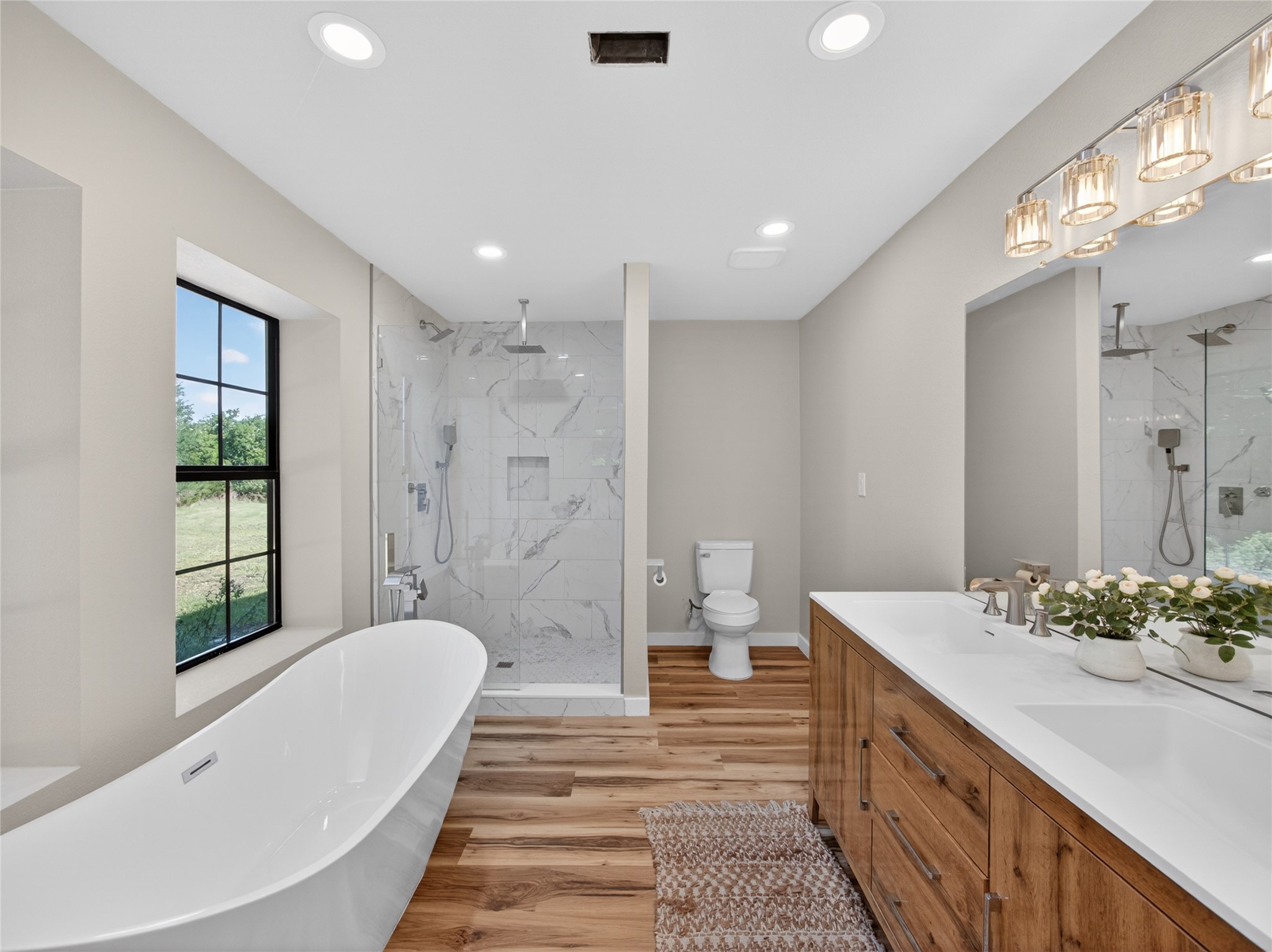 411 Avila Lane Briggs, TX 78608 - Photo 17 of 39 a bathroom with a tub sink shower and a mirror