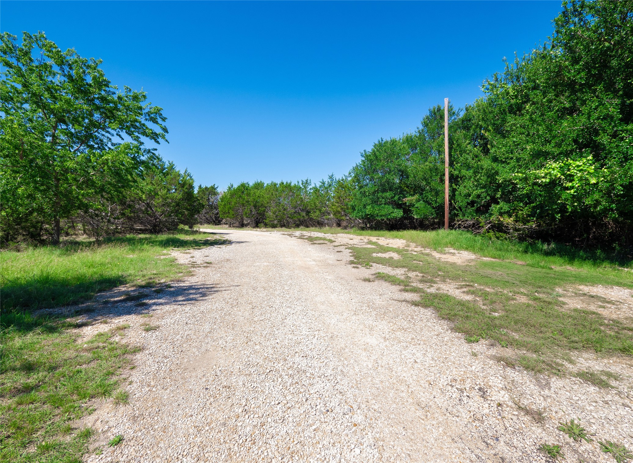 411 Avila Lane Briggs, TX 78608 - Photo 33 of 39 a view of a road with a yard